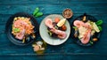 A set of seafood dishes on a blue wooden background. Pasta, bulgur, rice, couscous.