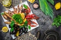 Set of seafood shrimp, fish, crayfish, mussels and soup on a dark background. Restaurant menu, dieting, cookbook recipe top view Royalty Free Stock Photo