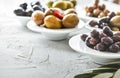 set of selected pickled olives in white bowls