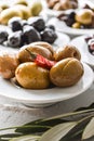 set of selected pickled olives in white bowls