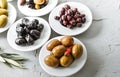 set of selected pickled olives in white bowls