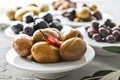 set of selected pickled olives in white bowls