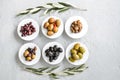 set of selected pickled olives in white bowls