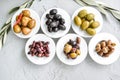 set of selected pickled olives in white bowls