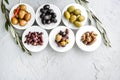 set of selected pickled olives in white bowls