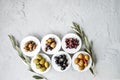 set of selected pickled olives in white bowls