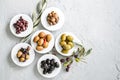 set of selected pickled olives in white bowls