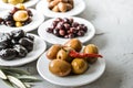 set of selected pickled olives in white bowls