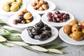 set of selected pickled olives in white bowls