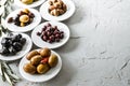 set of selected pickled olives in white bowls