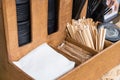 A set for self-service in a cafe. Caps for coffee cups, napkins, sugar and wooden sticks in a wooden box Royalty Free Stock Photo