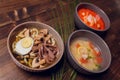 Set of Serving Asian Soups on gray background top view. Tom Yum Soup, Eel Fish Soup and Ramen noodle Soup. Royalty Free Stock Photo