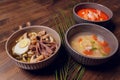 Set of Serving Asian Soups on gray background top view. Tom Yum Soup, Eel Fish Soup and Ramen noodle Soup. Royalty Free Stock Photo