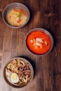 Set of Serving Asian Soups on gray background top view. Tom Yum Soup, Eel Fish Soup and Ramen noodle Soup. Royalty Free Stock Photo