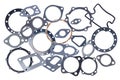 Set of several different metal and paronite engine gaskets, isolated on a white background Royalty Free Stock Photo