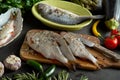 A set of fresh, raw fish in various dishes and with vegetables on a black table Royalty Free Stock Photo