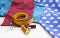 Set of several spools of thread, scissors, a tailor`s tape, several safety pins and some cloths. Royalty Free Stock Photo