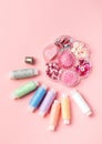 Set for sewing and handicraft: colorful spools thread, buttons, thimble, rhinestones and beads on a pink background Royalty Free Stock Photo