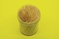 A set of sharp brown wooden toothpicks in a plastic box