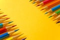 Set of sharpened colored pencils on a yellow background Royalty Free Stock Photo