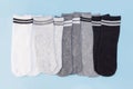Set of short socks white, gray, black striped on blue background Royalty Free Stock Photo