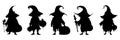 Silhouettes of Halloween characters holding pumpkin lanterns in a witch hat and cloak. Vector isolated illustration Royalty Free Stock Photo