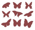 Set of silhouettes of nine beautiful flying butterflies