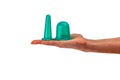 Set of silicone vacuum massage jars of different sizes on a woman`s hand, on a white background. Anti-cellulite silicone body