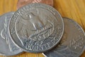 Set of silver Quarter Dollar coins currency in the USA, American Dollar on the wooden background