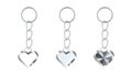 A set of silver or steel keychains in the shape of a heart. Metal key holders isolated on white. Realistic vector. Royalty Free Stock Photo