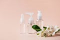 Set of similar plastic bottles with dispenser, pipette and flower tonic water