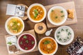 Set of six bowls with different soups combo menu on wooden table Royalty Free Stock Photo