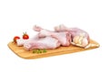 Set of six fresh raw chicken drumsticks on a wooden cutting Board with vegetables and herbs, on a white background Royalty Free Stock Photo