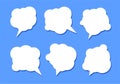 Set of six white speech bubbles with shadow on a blue background Royalty Free Stock Photo