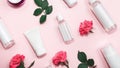 Set of skin care products on pink pastel background with roses flowers. Skin care concept. Womens day cosmetics Royalty Free Stock Photo