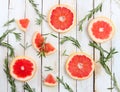 Set of sliced grapefruit with rosemary on wooden background Royalty Free Stock Photo