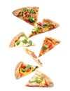 Set with slices of different pizzas falling on background