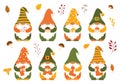 A set of small autumn dwarfs in caps, who hold mushrooms, twigs, berries and the letters FALL in their hands. Cute little forest