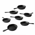 A set of small cast iron serving skillets f Royalty Free Stock Photo