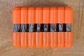 Set of metal bits for a screwdriver in an orange plastic box on the table Royalty Free Stock Photo