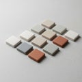 A set of small, square tiles arranged in a grid pattern on a speckled surface Royalty Free Stock Photo