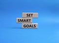 Set smart goals symbol. Concept words Set smart goals on wooden blocks. Beautiful blue background. Business and Set smart goals Royalty Free Stock Photo