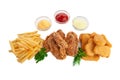 A set of snacks for beer. Consisting of French fries, nuggets and breaded chicken wings. Served with three sauces and herbs. White Royalty Free Stock Photo