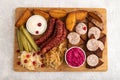 Set of snacks: sausages, toast, sauerkraut, marinated onion and cucumber, baked potato. Top view