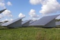 Set of solar power plants in the park under blue sky and white clouds Royalty Free Stock Photo