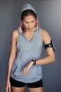 Set some goals, then demolish them. a sporty young woman checking the time on her sports watch against a gray background Royalty Free Stock Photo