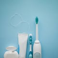 A set of sonic toothbrush, dental floss and toothpaste. Royalty Free Stock Photo