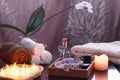 Set for spa treatments with electric burning candles and terry towels. In a wooden box, oil and stones for massage