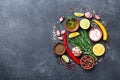 Set of spices and herbs on black stone table top view. Ingredients for cooking. Food background. Royalty Free Stock Photo