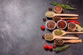 A set of spices and herbs. Indian cuisine. Pepper, salt, paprika, basil and other on a dark background